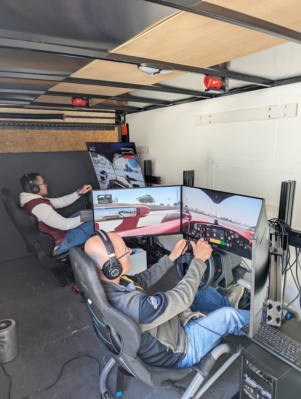 Two guests racing inside the Skid Mark mobile trailer