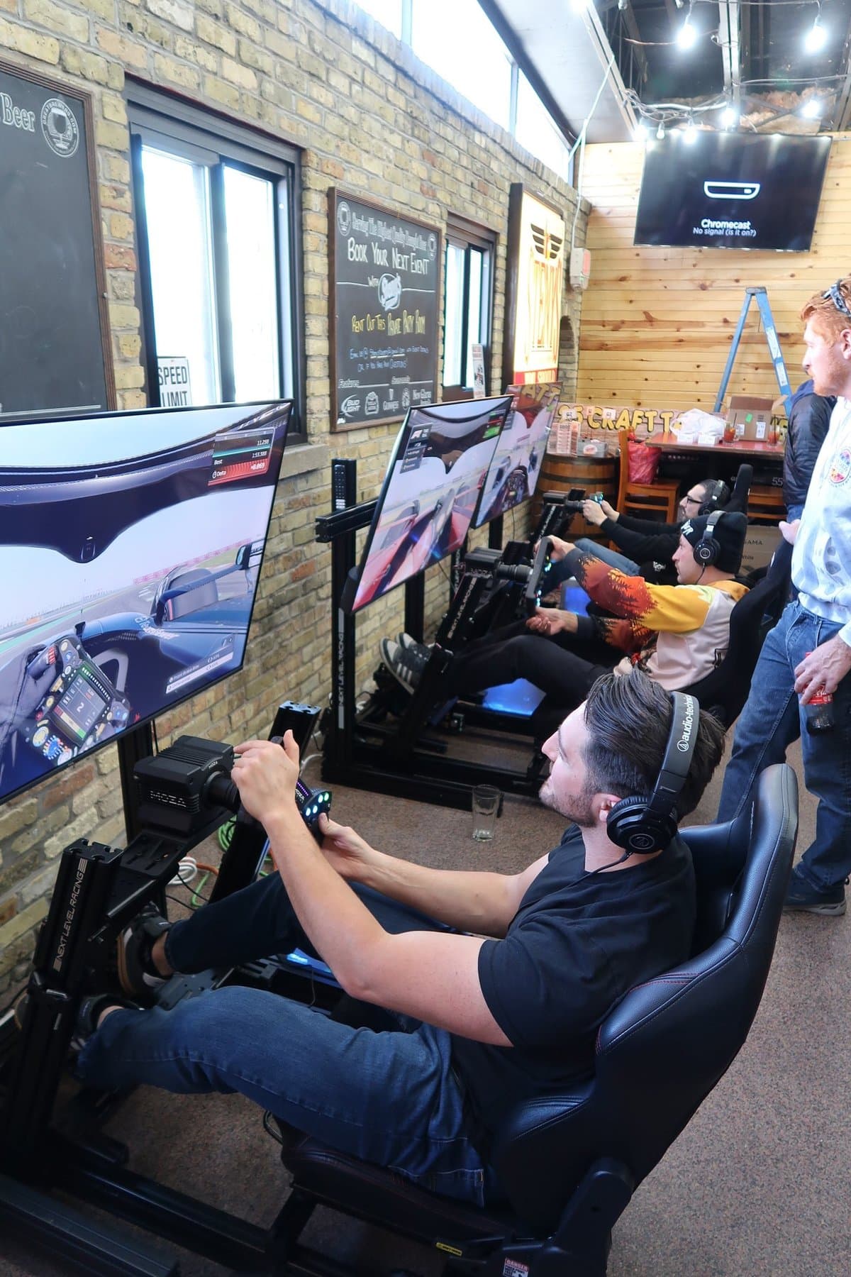 Three Skid Mark simulators arranged indoors at a Wisconsin venue