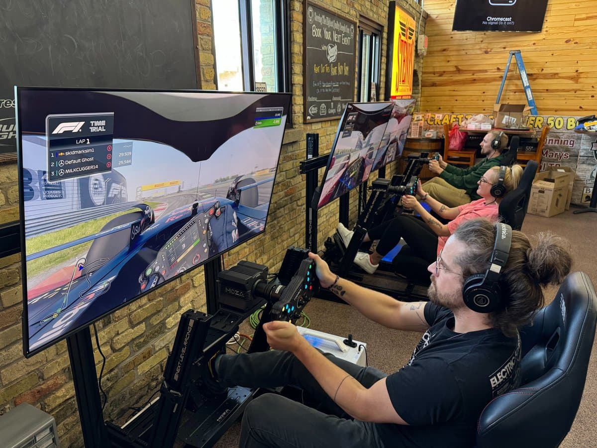 Three Skid Mark racing simulators running side by side at an event